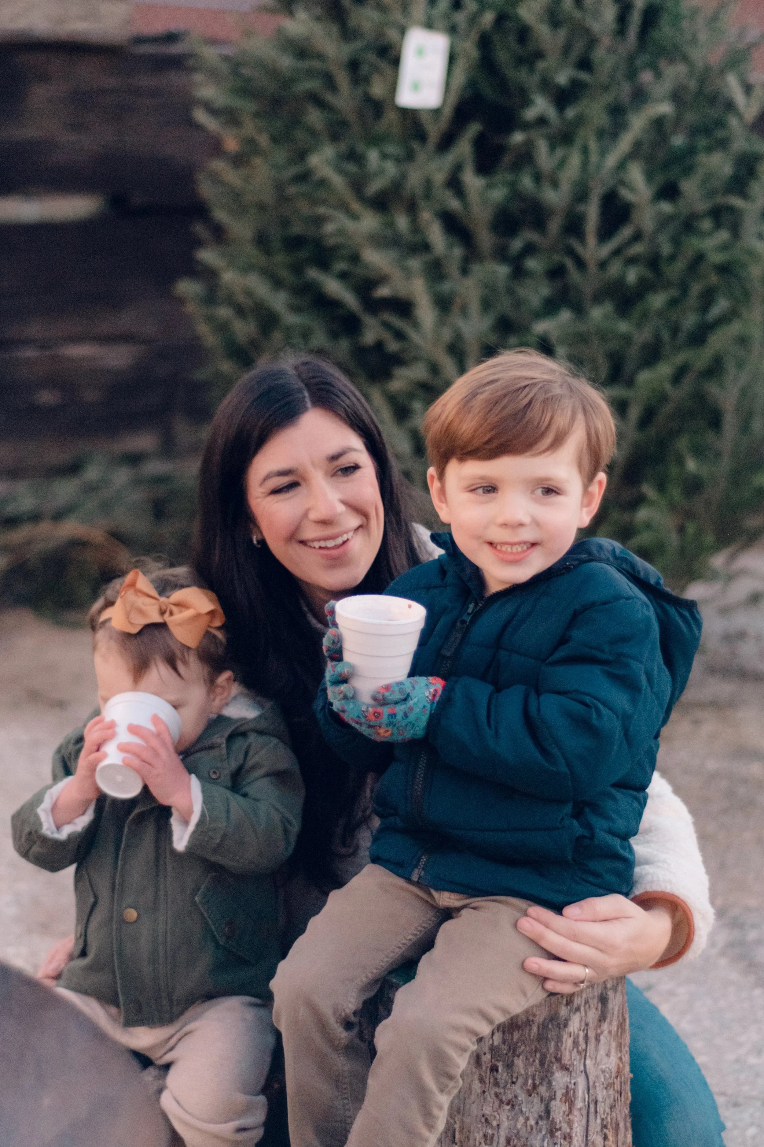 Family enjoying hot cocoa at Raise the Tree
