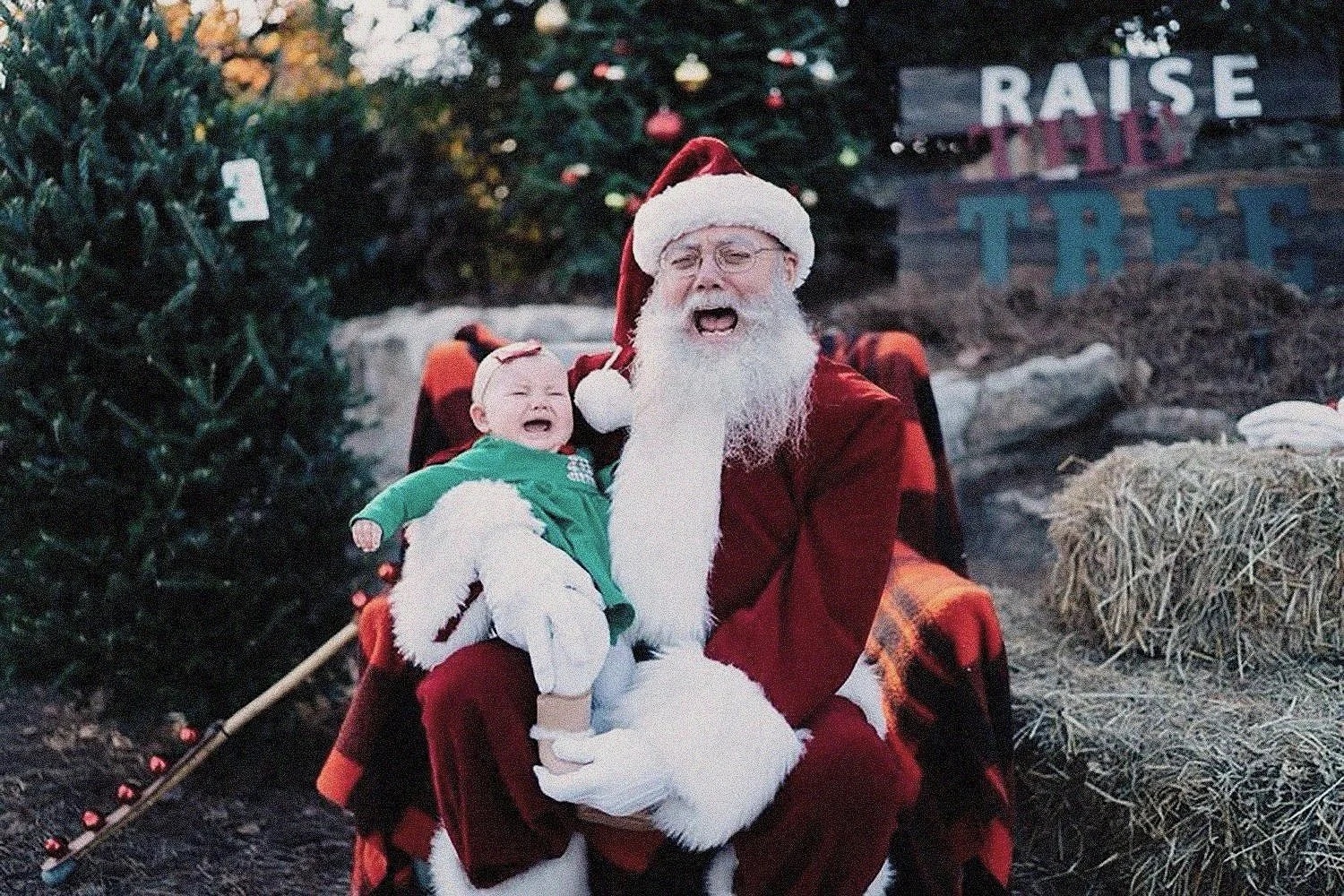 A baby meeting Santa at the farm